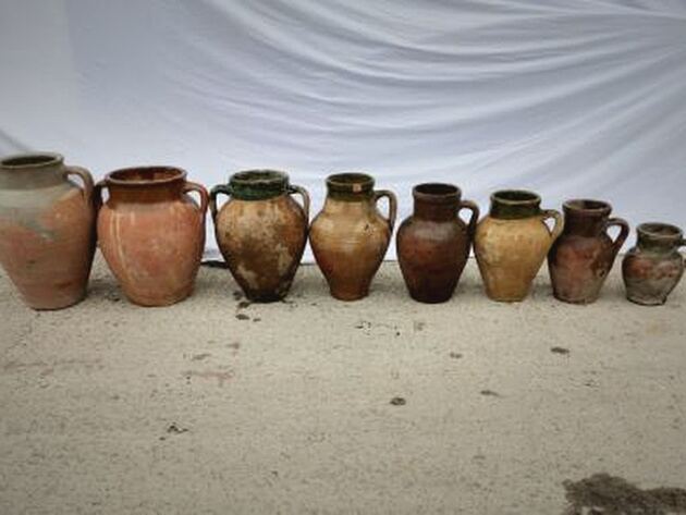 Konya Green Amphora, Small — row of nine small terracotta jars, several with green-glazed rims