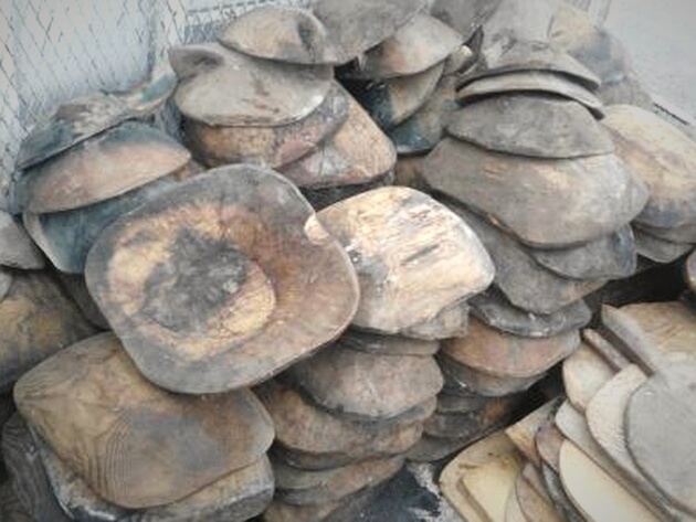 Wooden Trough, Round — heap of dark, rounded wooden troughs stacked together