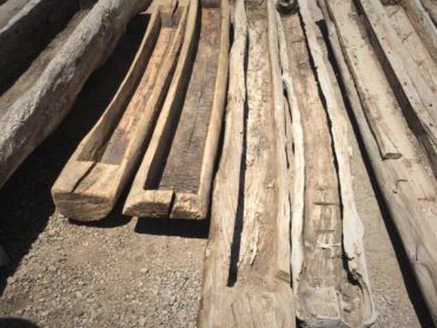 Reclaimed Wood Trough — long hollowed timber troughs, weathered, lying on the ground
