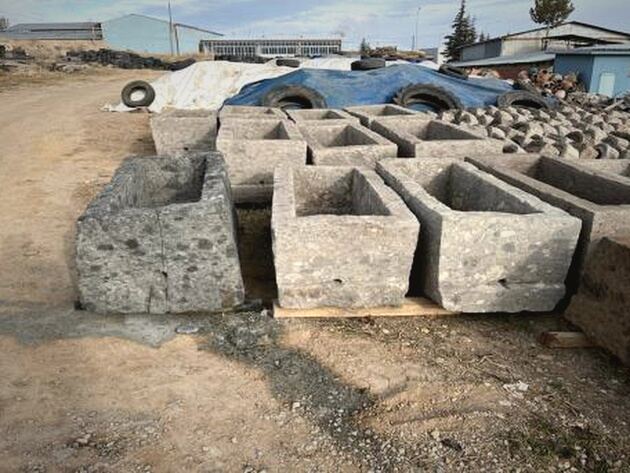 Limestone Trough — rectangular grey limestone troughs lined up on gravel