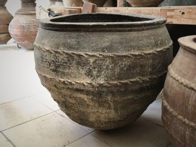 Olive Dağar Jar, II — broad brown clay jar with rope bands and a tapering base