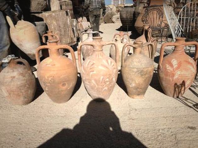 Amphora Jug — terracotta amphorae with painted foliage motifs standing in a row